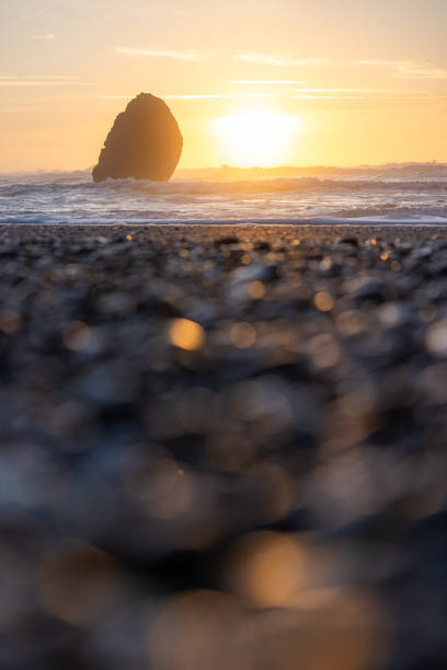 istock A rocky beach with a large rock in the foreground 2054339039