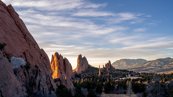 Garden of the Gods is a 1,341.3-acre public park located in Colorado Springs, Colorado, United States. Designated as a National Natural Landmark in 1971, this awe-inspiring destination features towering red rock formations set against the backdrop of snow-capped Pikes Peak and brilliant blue skies. Visitors can explore the geology, plants, animals, and people of this unique park. Notable attractions include the massive sandstone rock formations, including the famous Balanced Rock, and the Serpentine Trail that winds through the stunning landscape. The Garden of the Gods Visitor & Nature Center provides information, exhibits, and guided tours for an enriching experience.