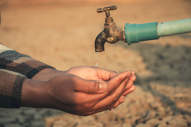 istock Hand for drinking water to live through drought, Concept drought and crisis environment. 2054459324