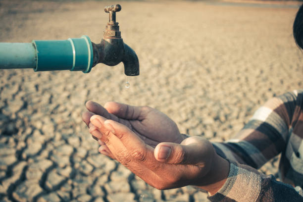 istock Hand for drinking water to live through drought, Concept drought and crisis environment. 2054459842
