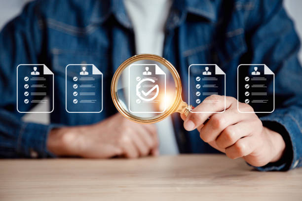 istock Businessman use magnifying glass focus to human icons for customer focus group. Data exchanges development and customer service , Customer relationship management concept. 2054493472