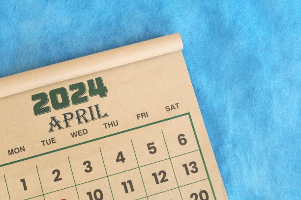 istock April 2024 calendar flat lay in blue background with copy space. 2054556988