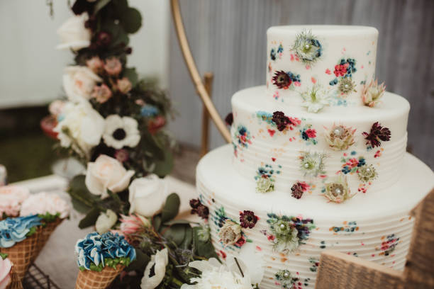 istock Watercolor wedding cake with pressed flowers on dessert table 2054594146