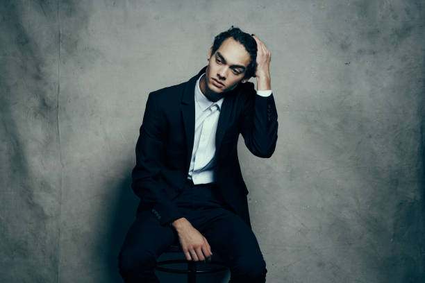 Portrait of an Asian businessman feeling pain in his head isolated over a white background. Concept of Indonesian business tired or work problem