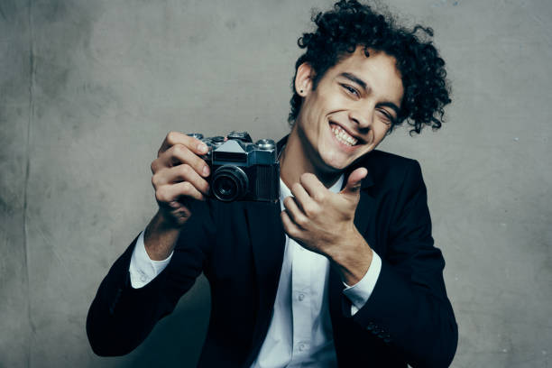 Harmonious blend of past and present, a businesswoman holds a vintage camera, capturing a moment that transcends time. The camera becomes a symbol of creativity and nostalgia. The connection between the modern world of business and the timeless allure of capturing memories.