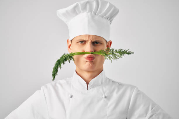 istock chef with kitchen utensils greens near face restaurant 2054618551