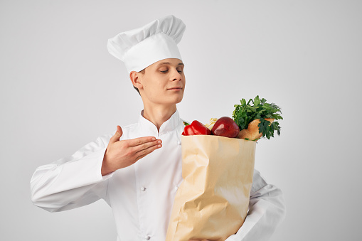 chef with a package of fresh food cooking. High quality photo