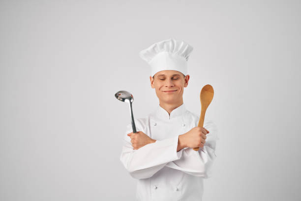 istock man in chef's uniform with kitchen utensils preparing food Professional 2054630307
