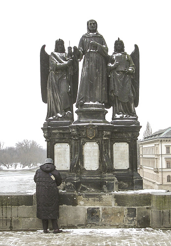Prague, Czechia, February 24, 2006 : Well preserved statue of St Frances Serafinski Assisi on the Charles Bridge in old town of Prague the capital of the Czech Republic