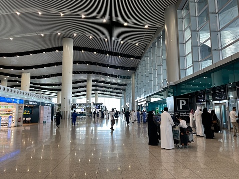 Riyadh , Saudi Arabia - Mar 11 2023 : Passengers traveling through King Khalid International Airport Riyadh Airport - flight  and booking concept