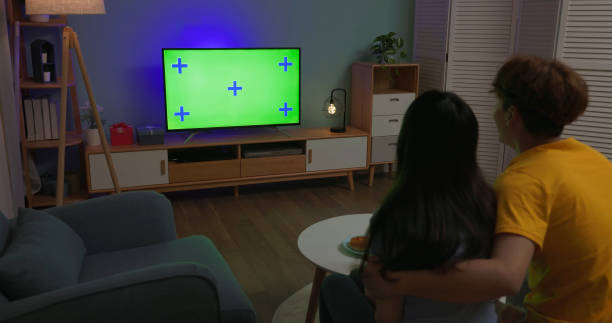 istock couple watch TV green screen 2054740002