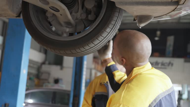 A technician rotates the tires of a car to check the condition of the tires.