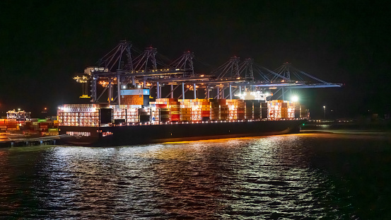 Felixstowe, Suffolk, England, UK - November 15, 2022: A container freighter in the port at night