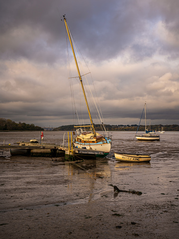 Pin Mill, Suffolk, England, UK - November 22, 2022: Boats in the harbour at low tide