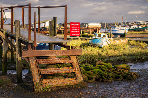 Pin Mill, Suffolk, England, UK - November 22, 2022: Boats in the harbour at low tide