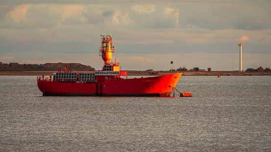 Shotley Gate, Suffolk, England, UK - November 22, 2022: View across the River Orwell to a Lighthouse ship near Felixstowe Harbour