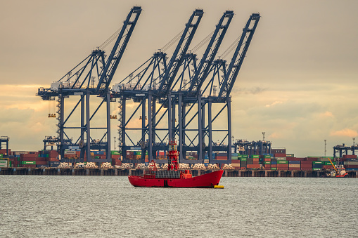 Shotley Gate, Suffolk, England, UK - November 22, 2022: View across the River Orwell to a Lighthouse ship near Felixstowe Harbour