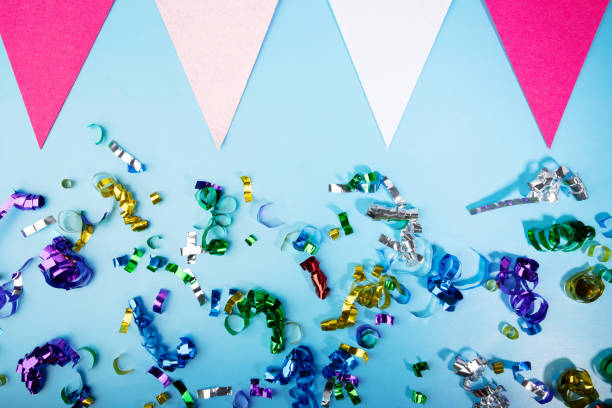 istock Confetti and holiday flags on blue background, festive celebration, party decor, carnival atmosphere 2054787300