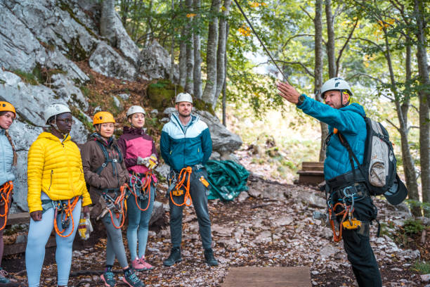 istock Diverse Group of Adventurers Receiving Safety Briefing from Instructor at Zip Line Course 2054798407