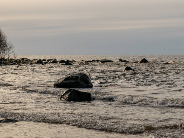 istock landscape with stony beach and lonely man silhouette in the evening 2054815187