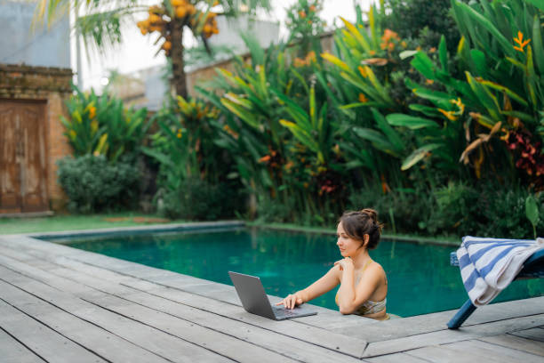 istock Woman working with laptop from swimming pool 2054820248
