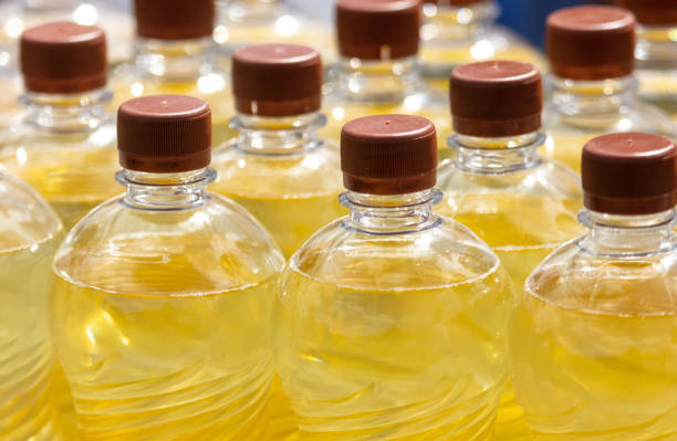 istock Bottles of sunflower oil on a light background. Selective focus 2054834316
