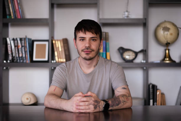 handsome man looking at camera sitting at desk