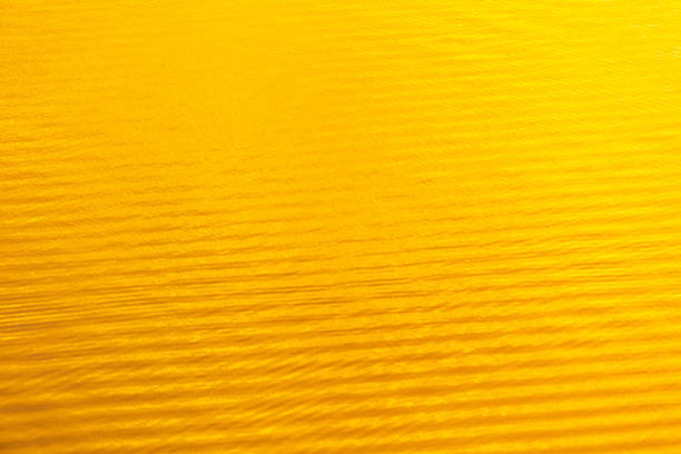 Water ripples in golden tones. Abstract background and texture for design.