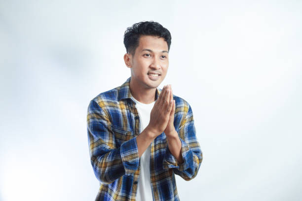 istock Adult Asian man smiling friendly while greeting someone 2054858427