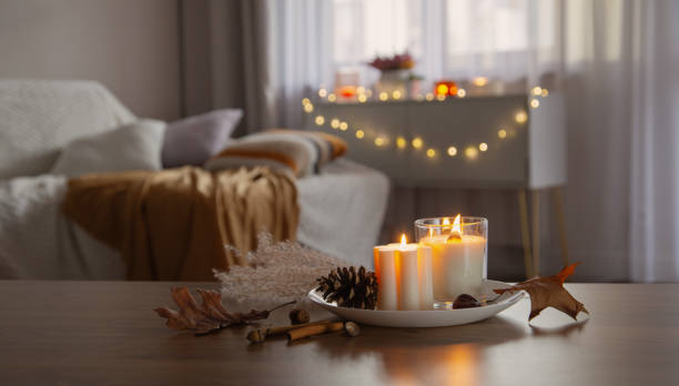 istock autumn and winter home decor with burning candles 2054861053