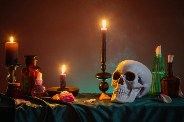 istock scull and burning candles with halloween decor on dark background 2054861543