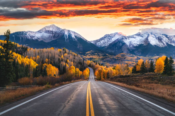 Stunning Sunset Sky Over Colorado Highway with San Juan Mountains Stunning sunset Sky Over Colorado Highway with San Juan Mountains in the distance, near Telluride aspen tree stock pictures, royalty-free photos & images