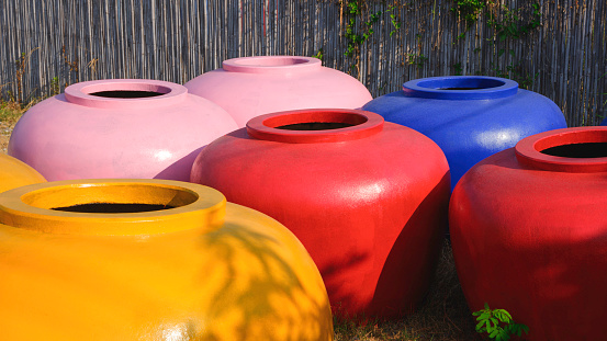 Group of large colorful water jars with a capacity of 2000 liters of water for sale in rural village at Thailand