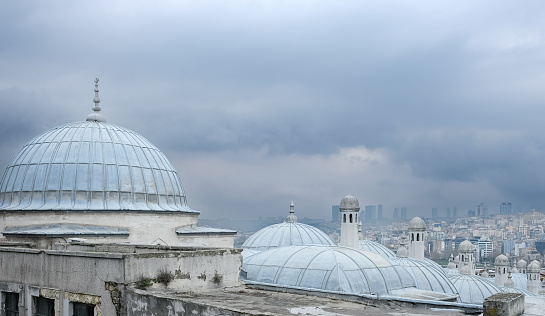 Yeni Cami Mosque The New Mosque in Istanbul Turkey. Domes of Yeni Cami Mosque on a cloudy day. Travel photo, copy space for text