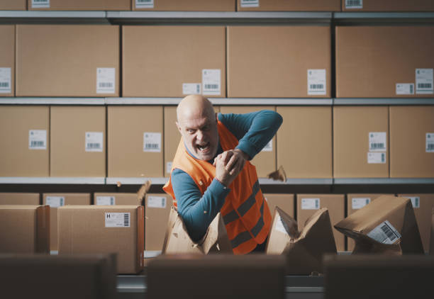 istock Furious rebellious worker tearing boxes at the warehouse 2054897580