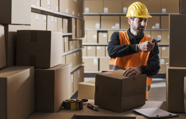 istock Warehouse clerk scanning labels on packages 2054903427