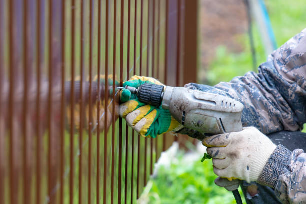 istock Workers install a metal profile fence 2054903441