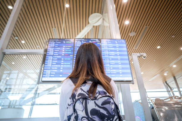 istock Female Tourist Traveling Checking Flight Details 2054918168
