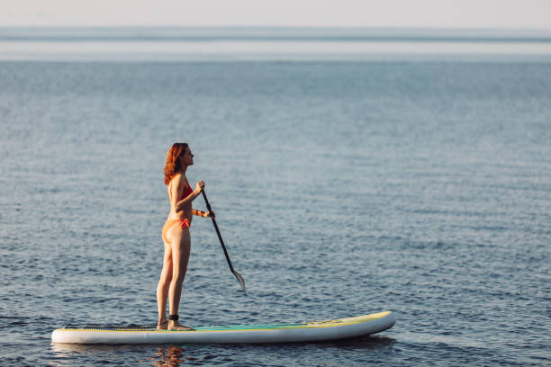 istock One woman paddleboarding at the lake 2054924866