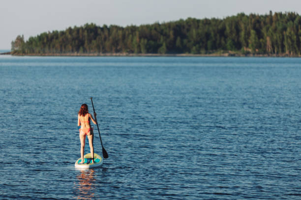 istock One woman paddleboarding at the lake 2054927457