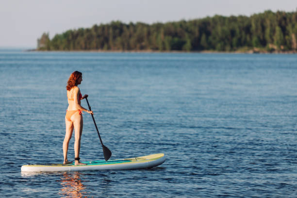 istock One woman paddleboarding at the lake 2054928485