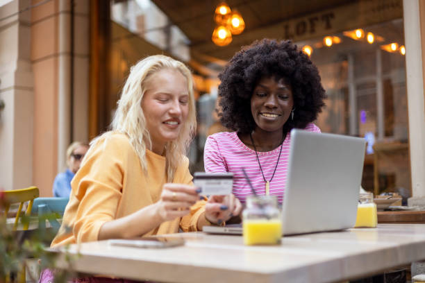 istock Female Doing Online Shopping in Coffee Shop 2054928500