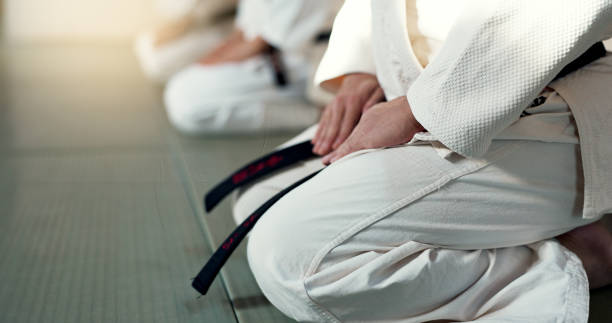 istock Japanese men, aikido and bow in training for fighting, modern martial arts and learning self defence. Group, black belt students or instruction in dojo place, sport or class in respect in discipline 2054929019