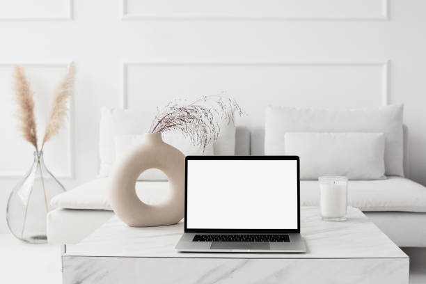 istock Working at home. Laptop with blank empty screen mockup in a living room 2054936391