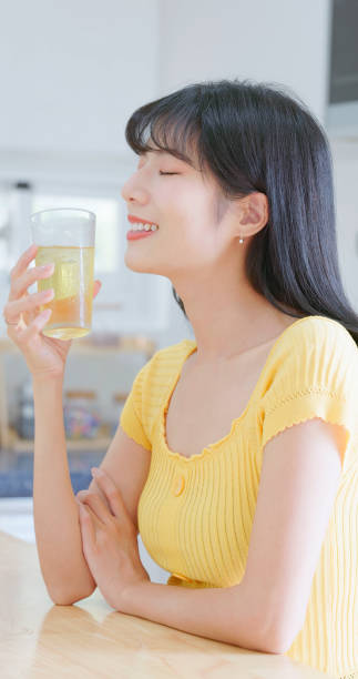 istock asian woman happily drink icewater 2054943180