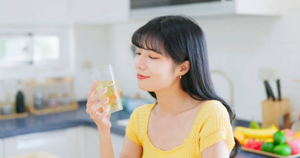 istock asian woman happily drink icewater 2054943555