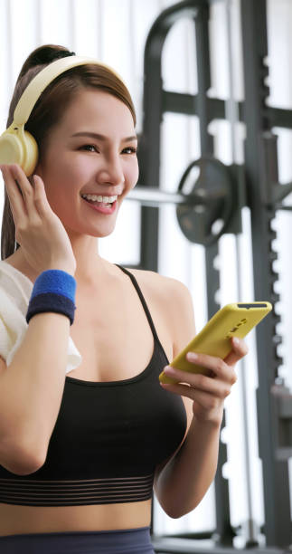 istock female smartphone headset at gym 2054945250