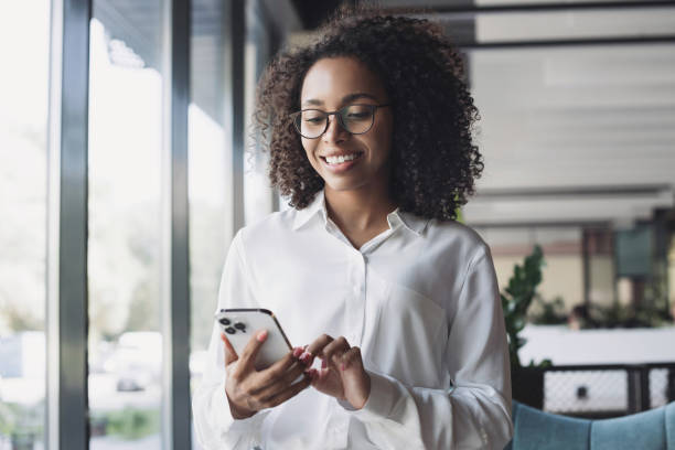 istock Young woman using smartphone in office 2054952164