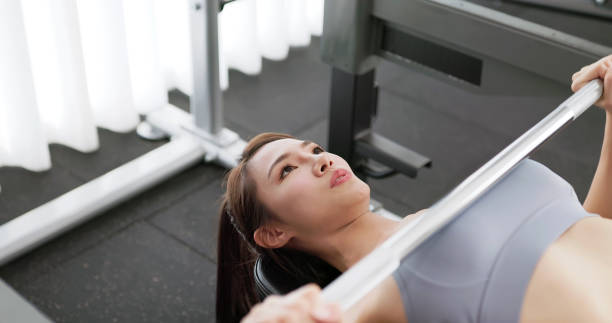 asian female gym bench press