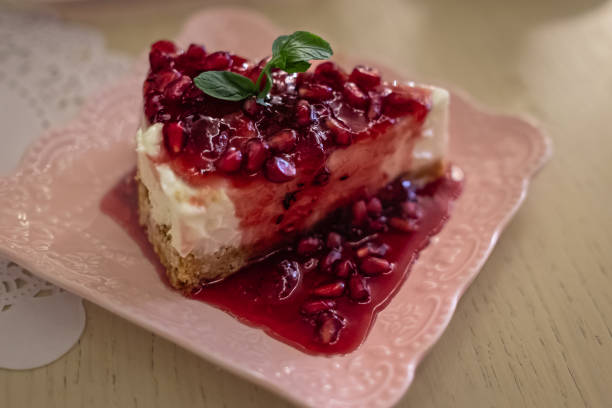 istock Plate with delicious cheesecake slice with pomegranate jam. Delicious cheesecake 2054996290